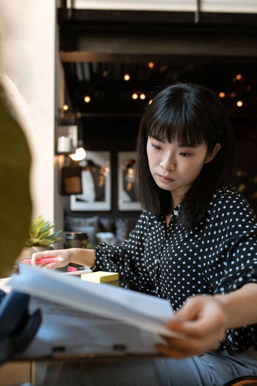 A professional reviewing documents at a modern office desk